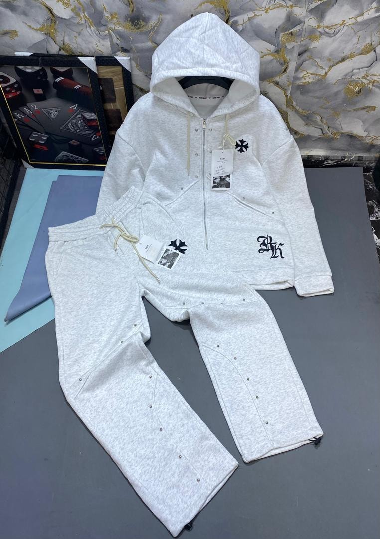 White studded zip hoodie and jogger set with cross emblems and embroidery.