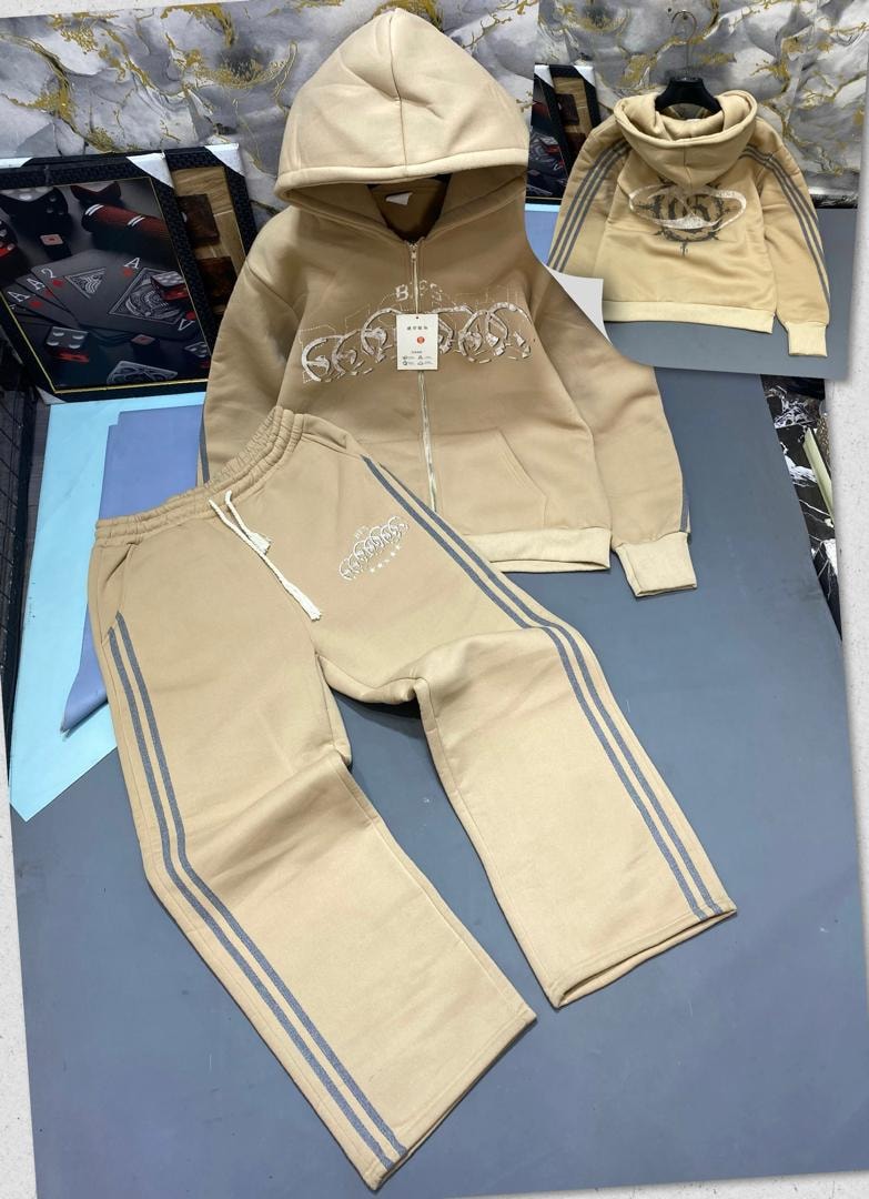 Beige zip-up hoodie and jogger set with chain embroidery and striped sides.