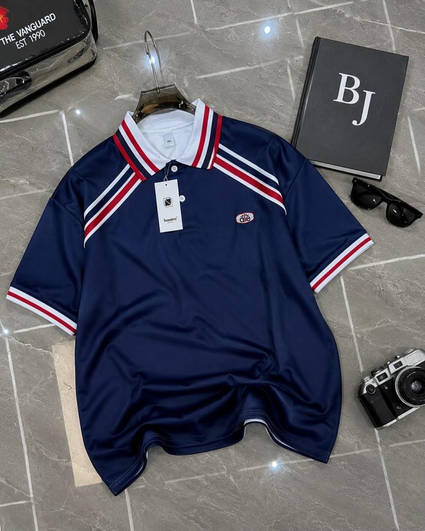 Navy polo shirt with red white and blue striped trim on collar and sleeves.