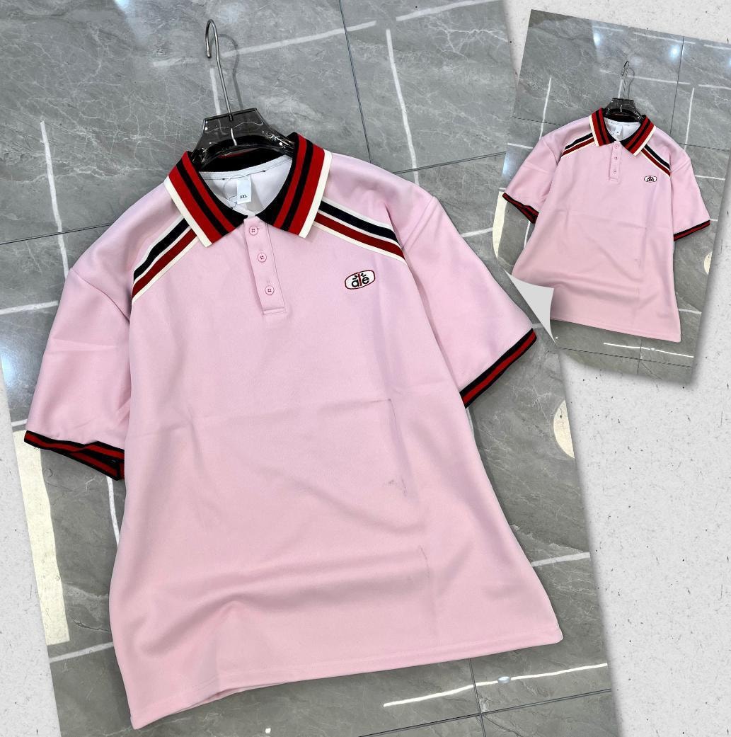 Pink polo shirt with red black and white striped collar and sleeves.