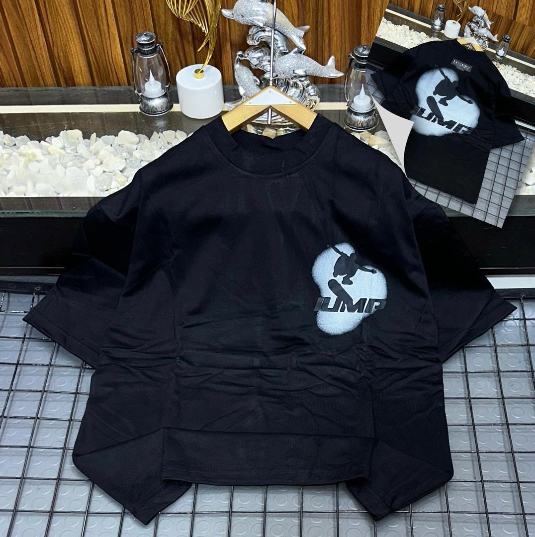 Black oversized t-shirt with white skateboarder jump graphic and JUMP text on chest, back view inset.
