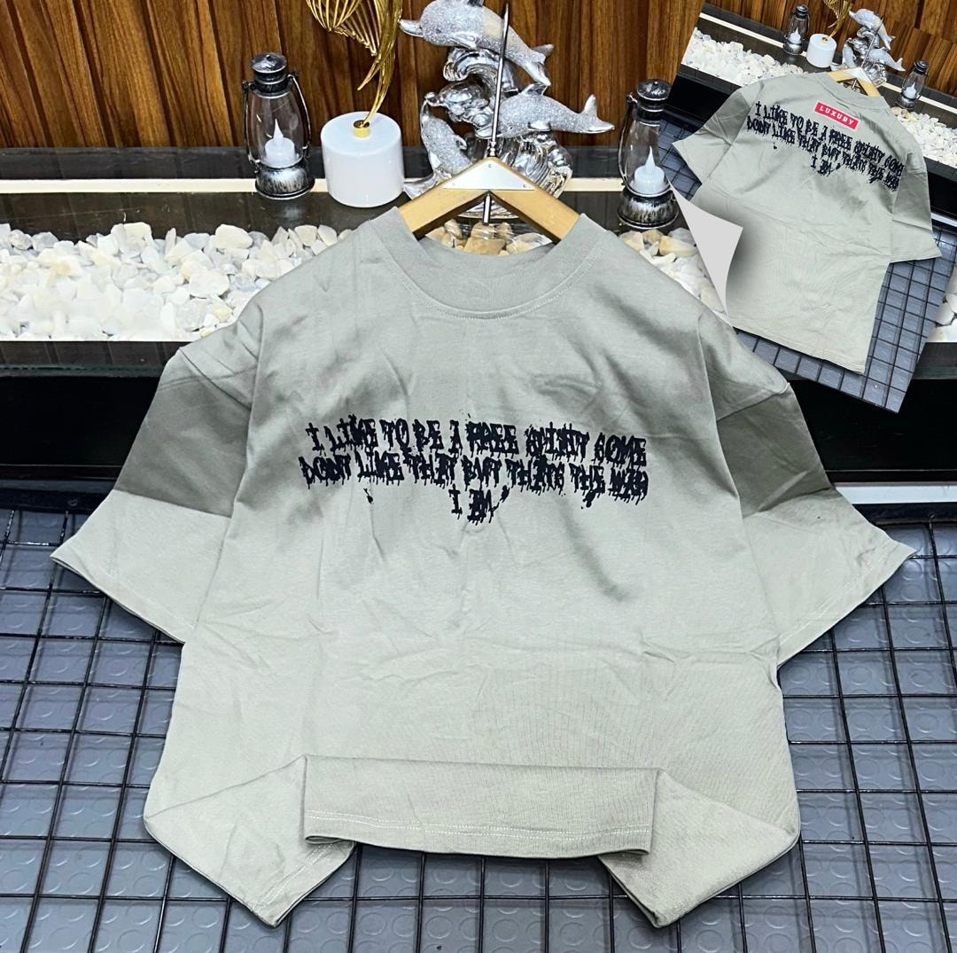 Beige oversized t-shirt with black dripping quote print on front and back views.