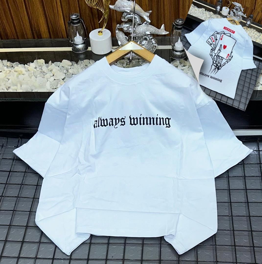 White oversized t-shirt with black 'always winning' gothic text on front and skeleton card graphic on back.