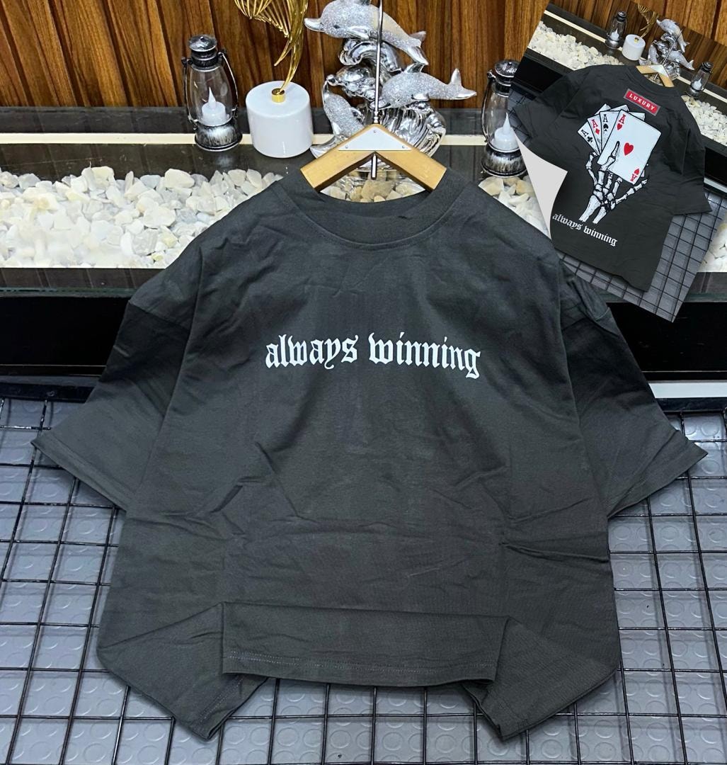 Gray oversized t-shirt with white 'always winning' gothic text on front and skeleton card graphic on back.