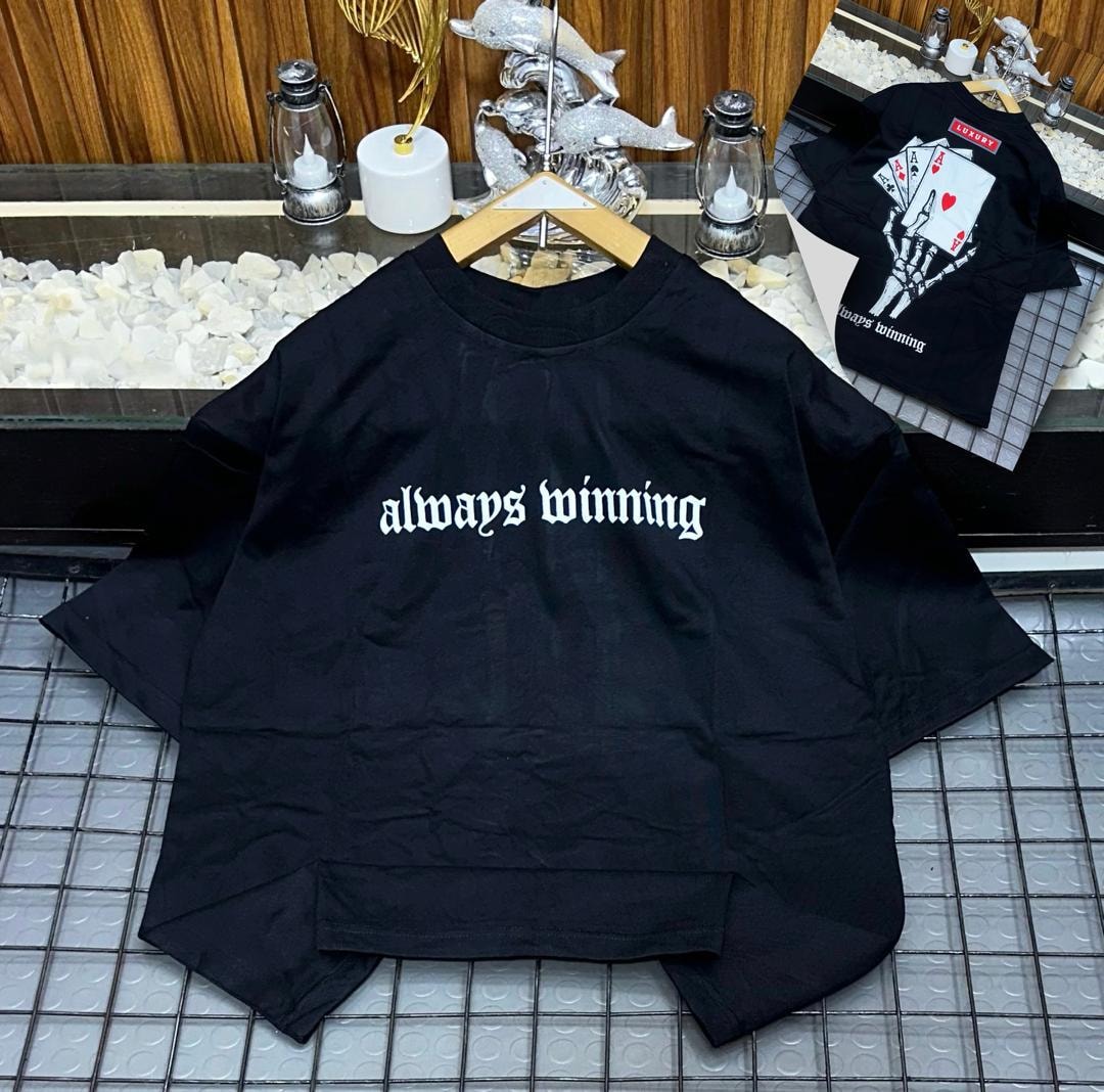 Black oversized t-shirt with white 'always winning' gothic text on front and skeleton card graphic on back.