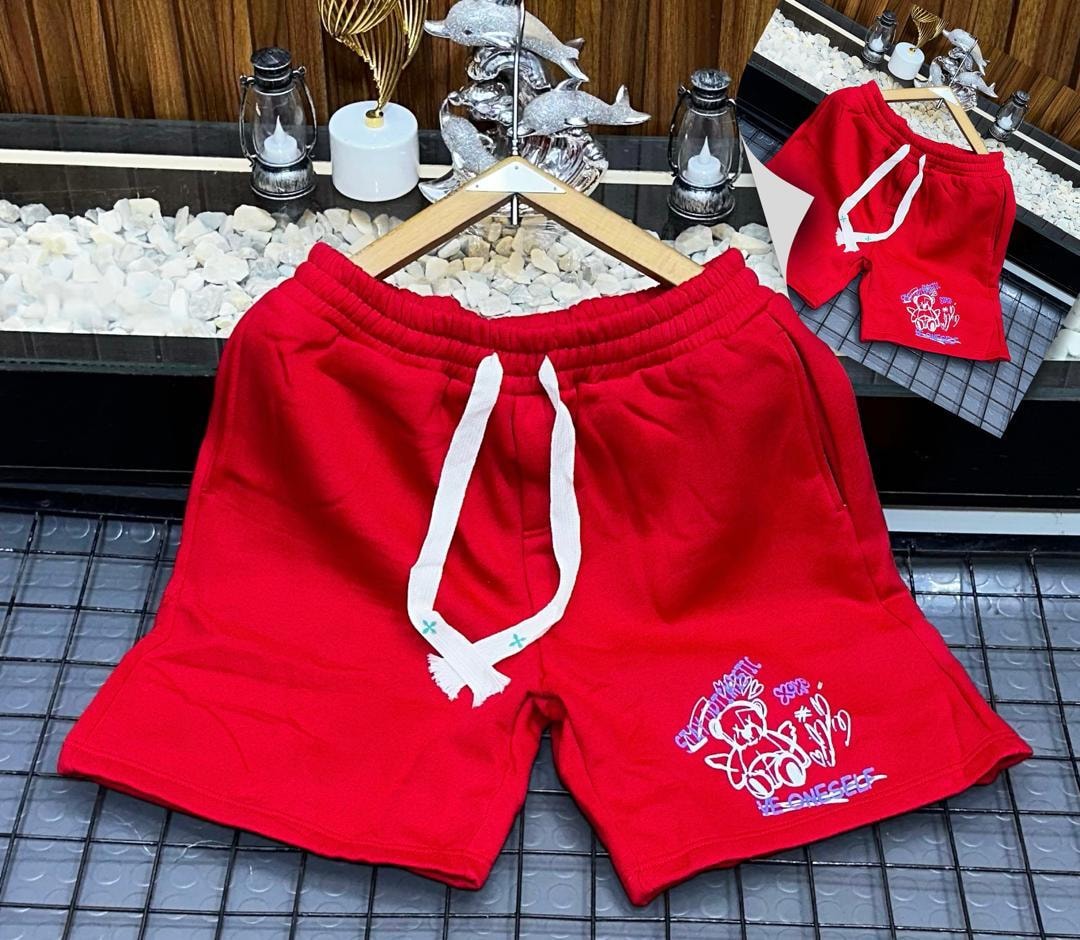 Red fleece shorts with teddy bear graphic print on leg.