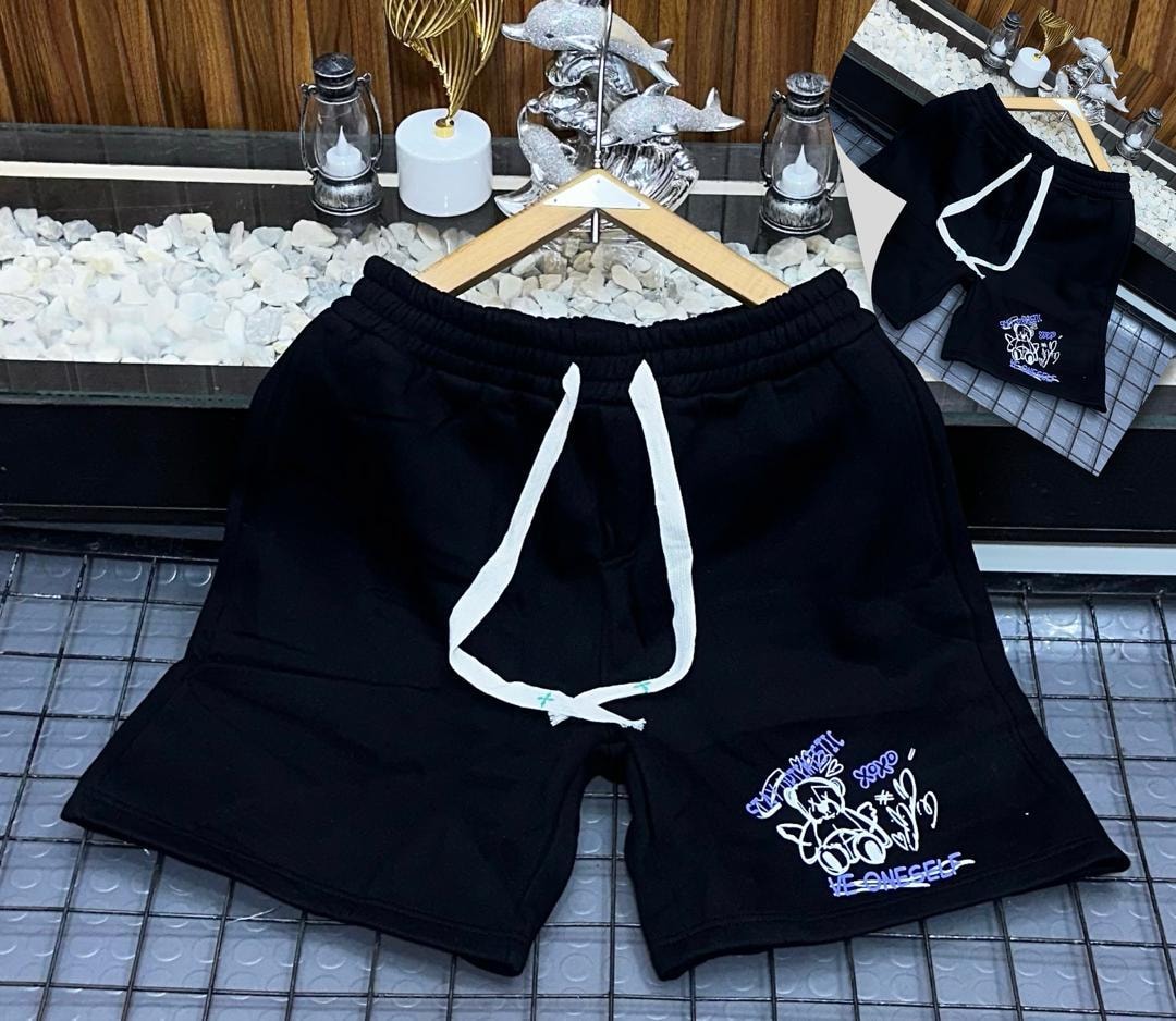 Black fleece shorts with teddy bear graphic print on leg.