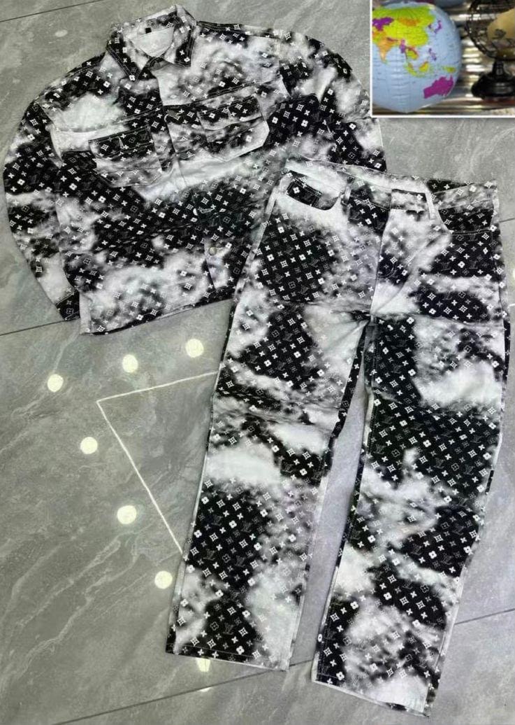 Black and white monogram patterned denim long-sleeve shirt and pants laid on tiled floor.
