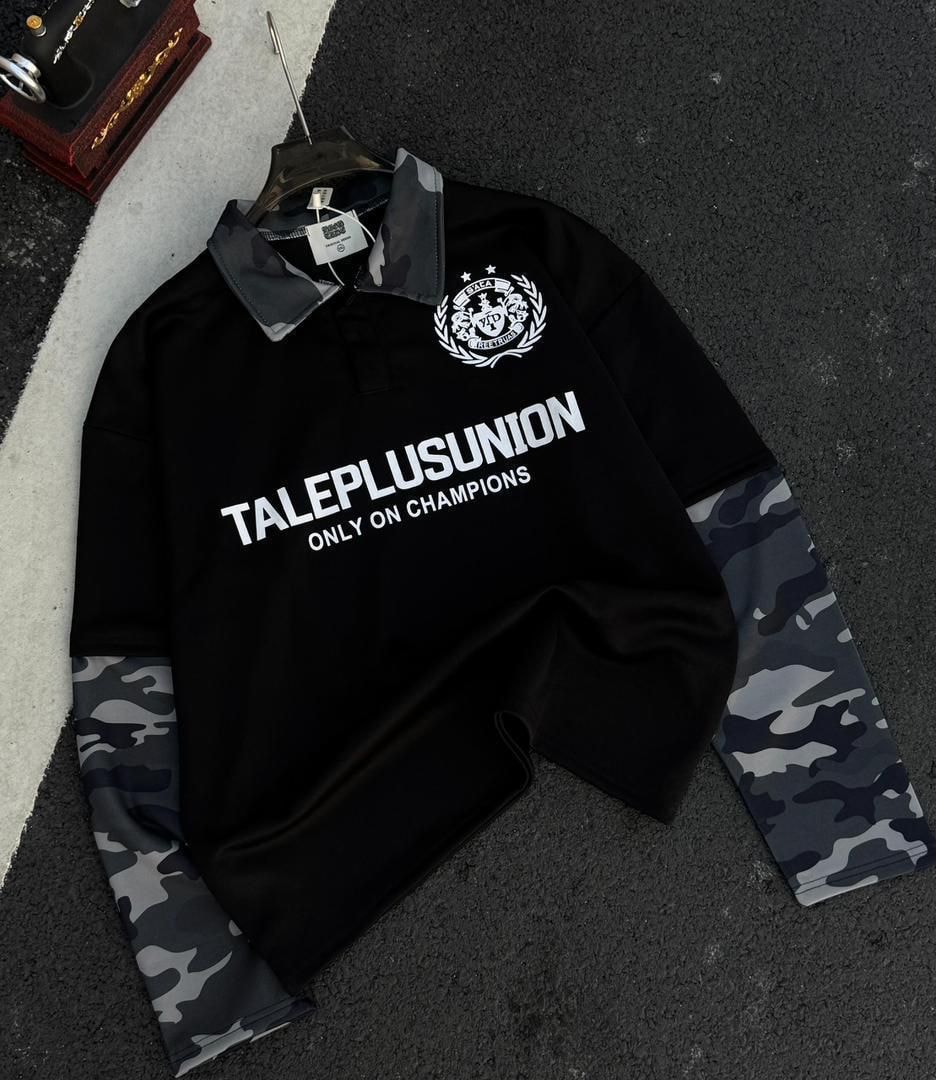 Black long sleeve polo with gray camo collar and sleeves plus white chest graphic.