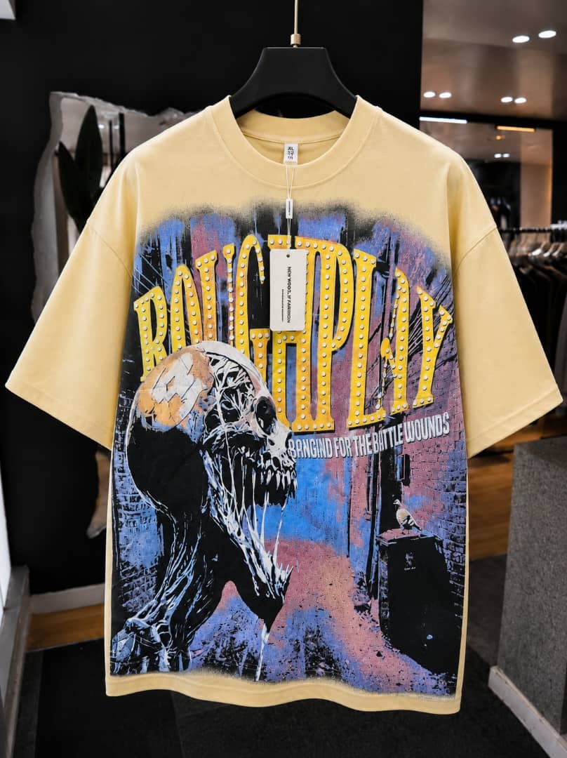 Yellow oversized t-shirt with roughplay skull and marquee graphic print.