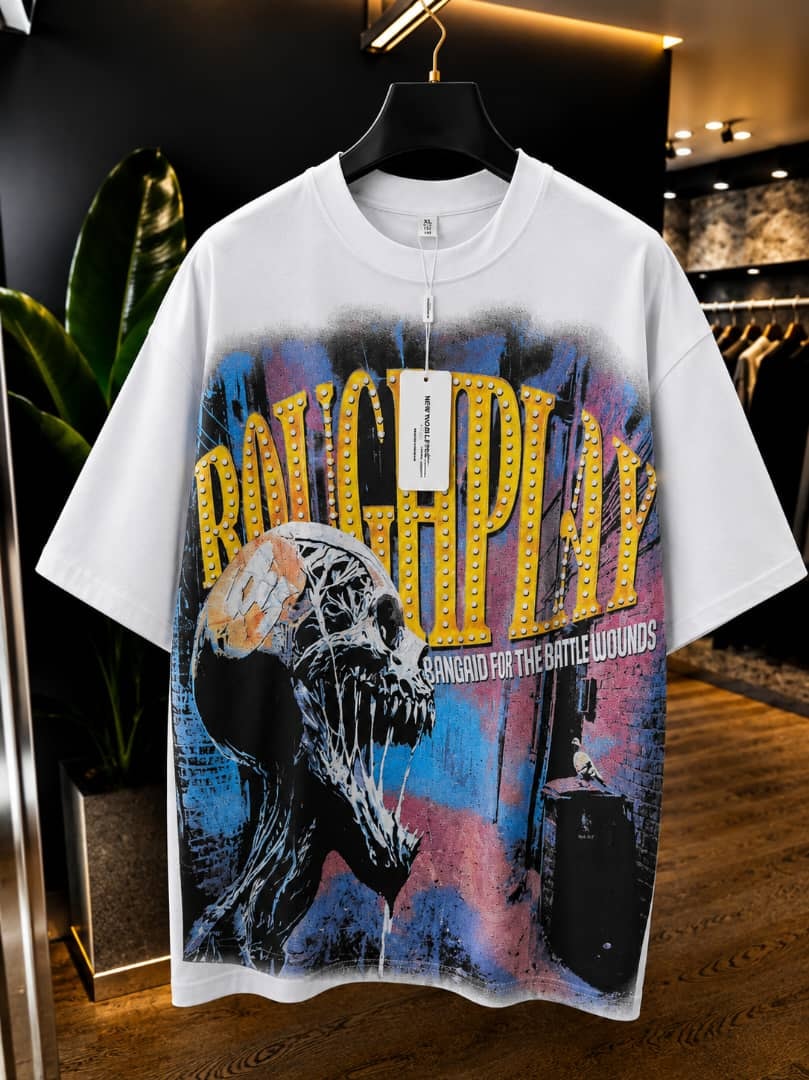 White oversized t-shirt with roughplay skull and marquee graphic print.
