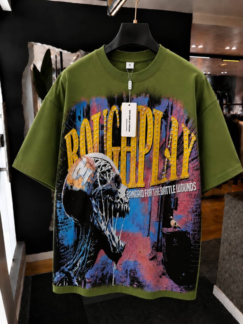 Olive oversized t-shirt with roughplay skull and marquee graphic print.