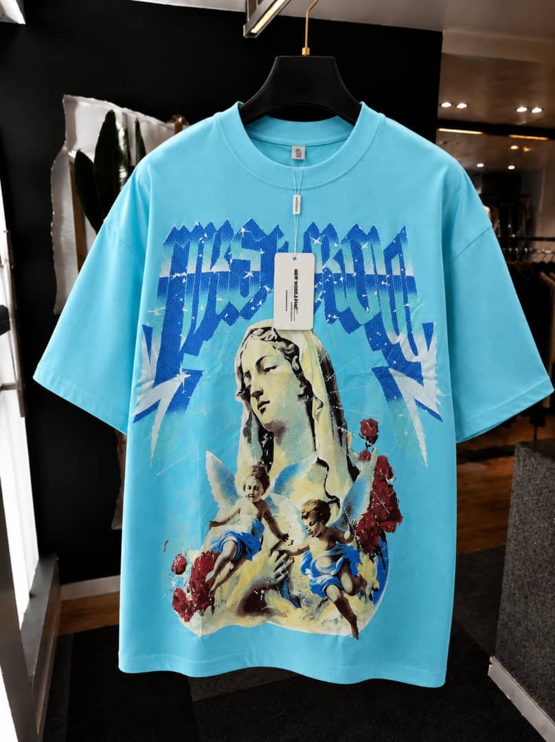 Turquoise oversized t-shirt with large front graphic print of a female figure, angels and roses.