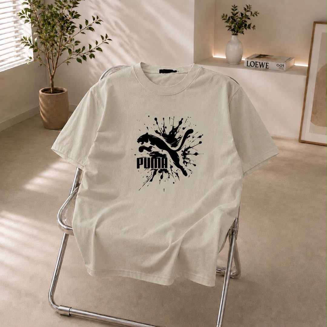 Cream t-shirt with black Puma splash logo on the chest.