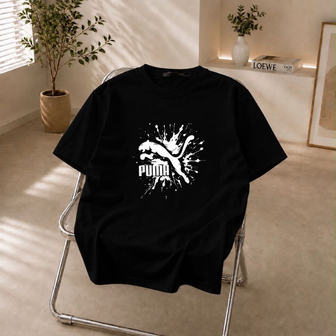 Black t-shirt with white Puma splash logo on the chest.