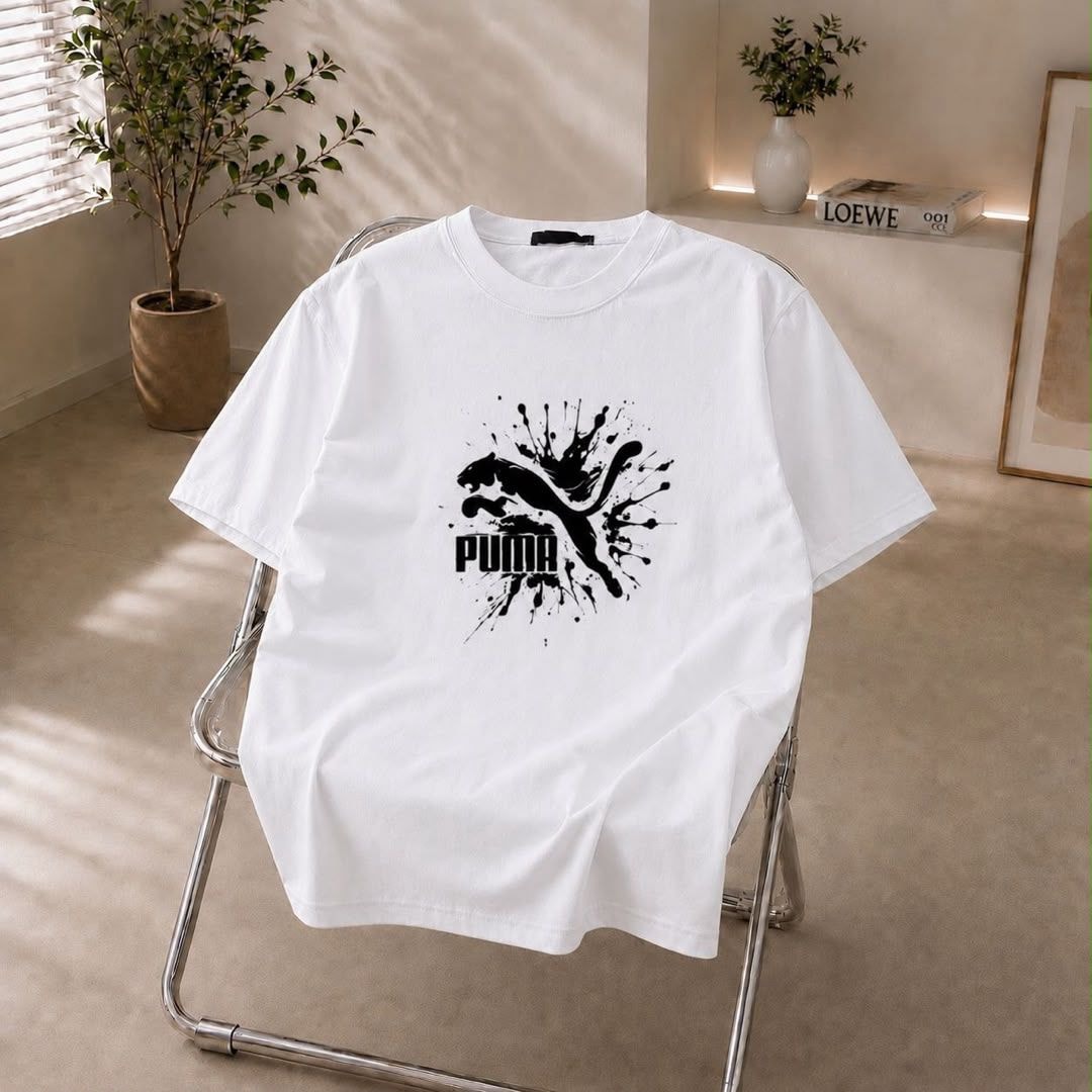 White t-shirt with black Puma splash logo on the chest.