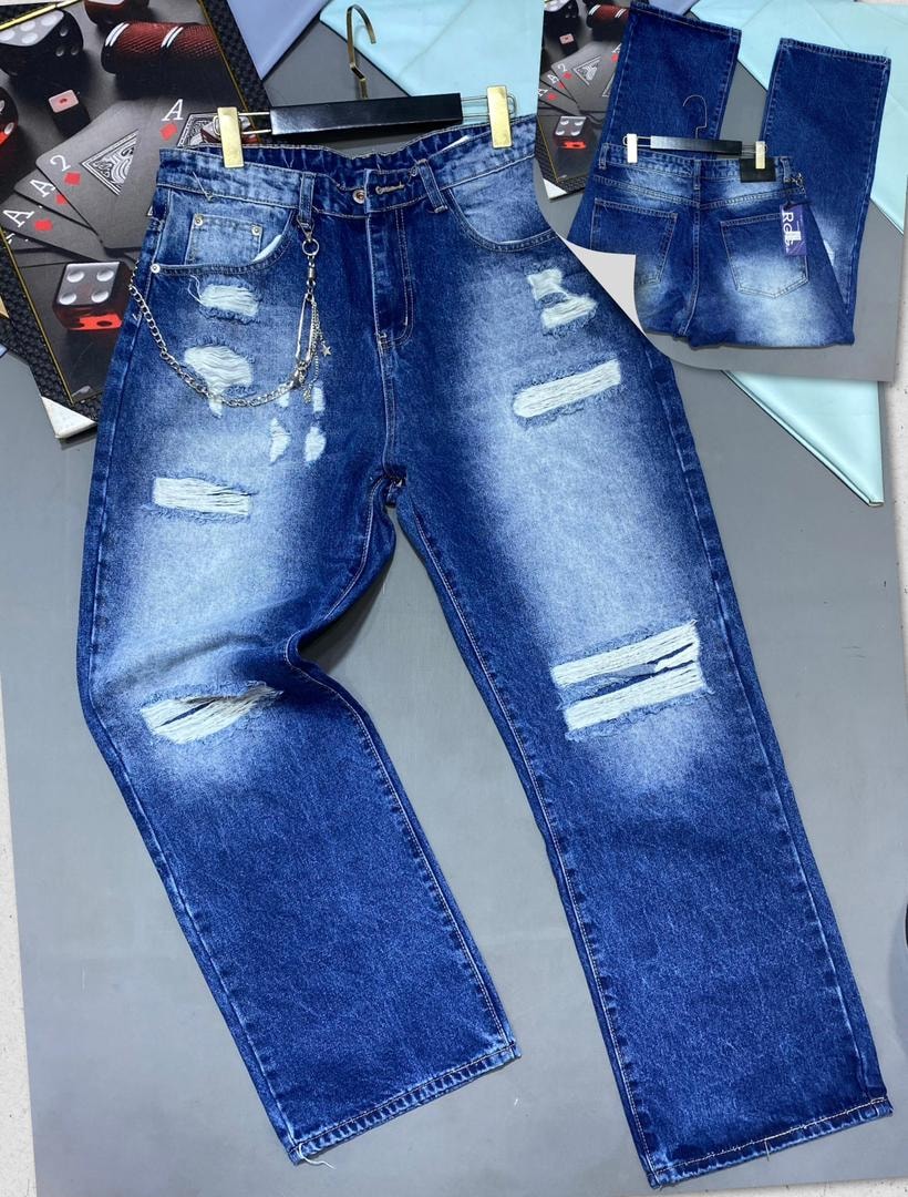Blue baggy jeans with large horizontal rips and silver chain shown from front with inset back view.