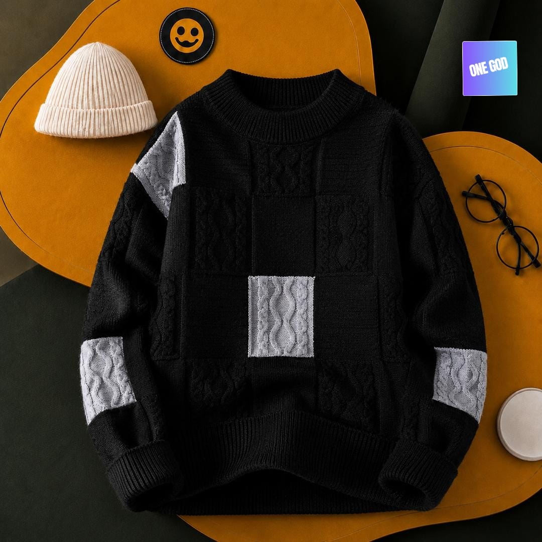 Black cable knit sweater with gray patchwork panels and textured details.