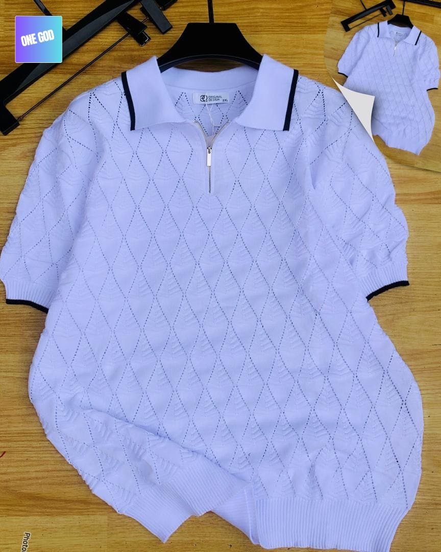 Light purple argyle knit quarter-zip polo shirt laid flat on wooden surface.