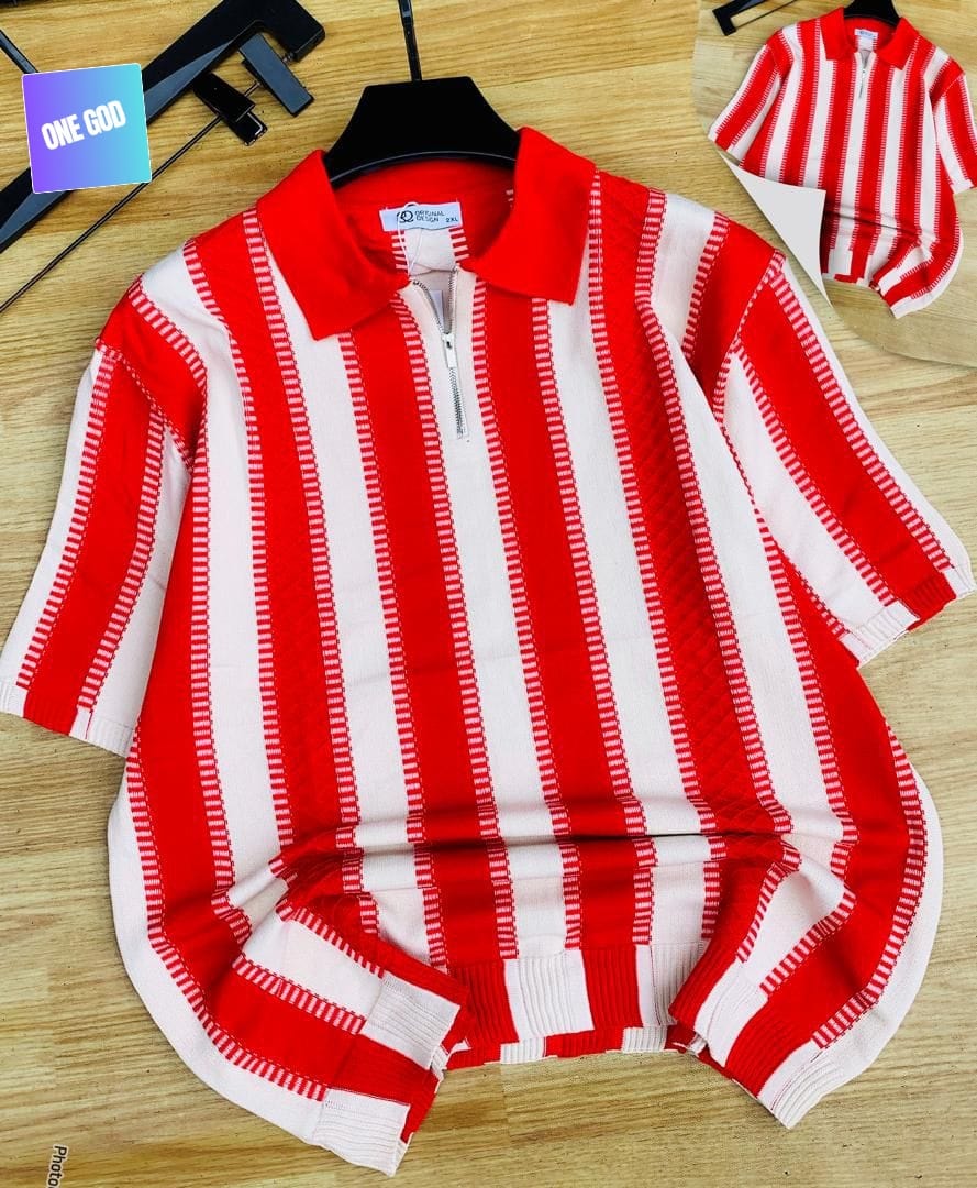 Red and white vertically striped quarter-zip knit polo on hanger with wooden background.