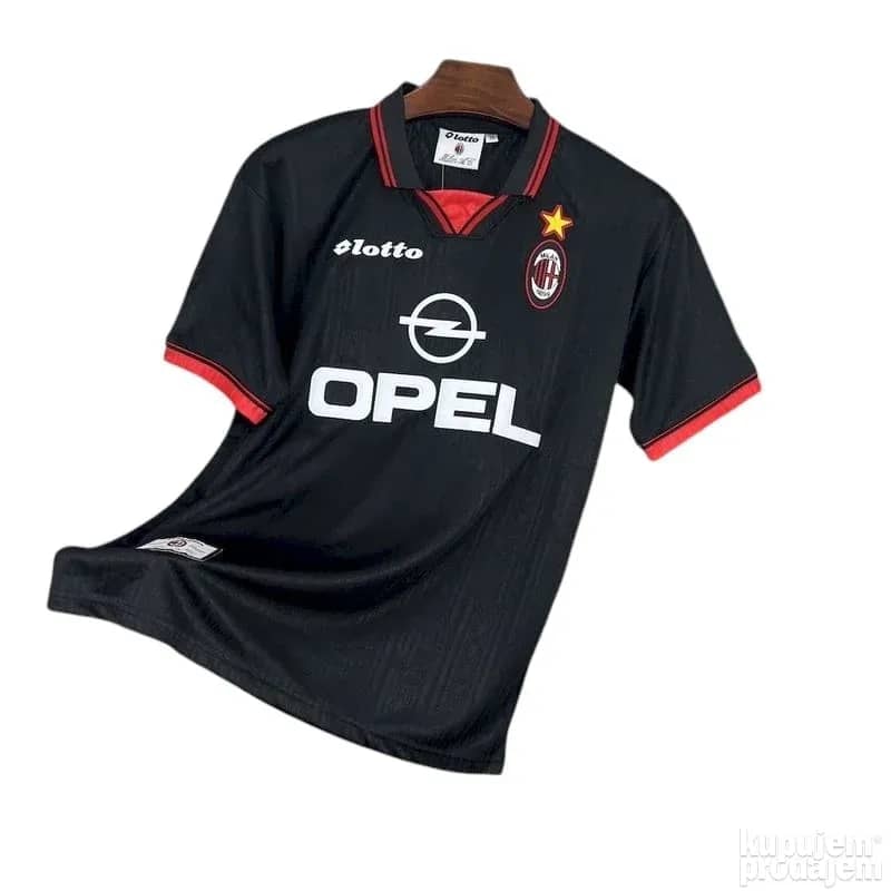 Black vintage AC Milan Lotto Opel football jersey on hanger against white background.