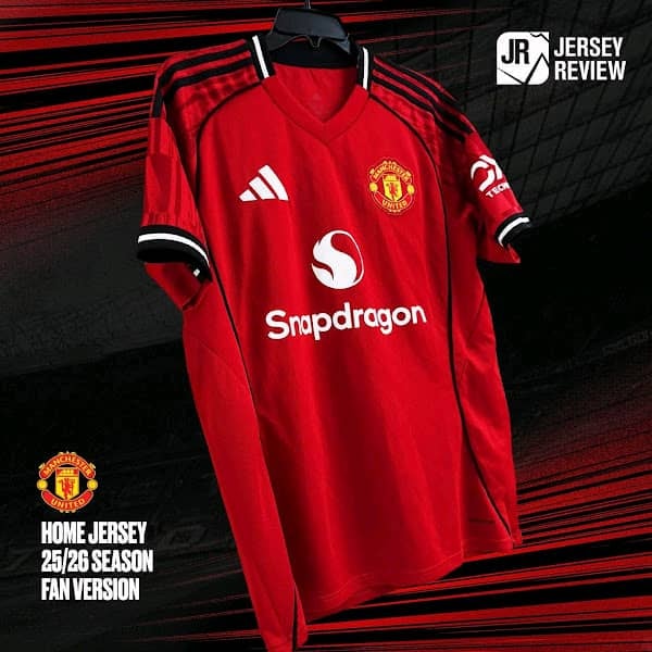 Red Manchester United long sleeve Adidas football jersey in dramatic lighting.