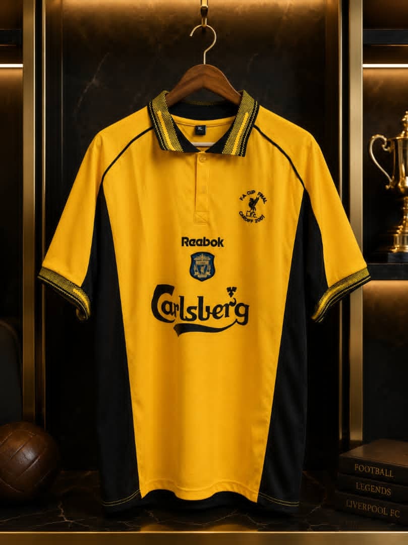 Yellow and black retro Liverpool FC Reebok polo jersey displayed with trophies.