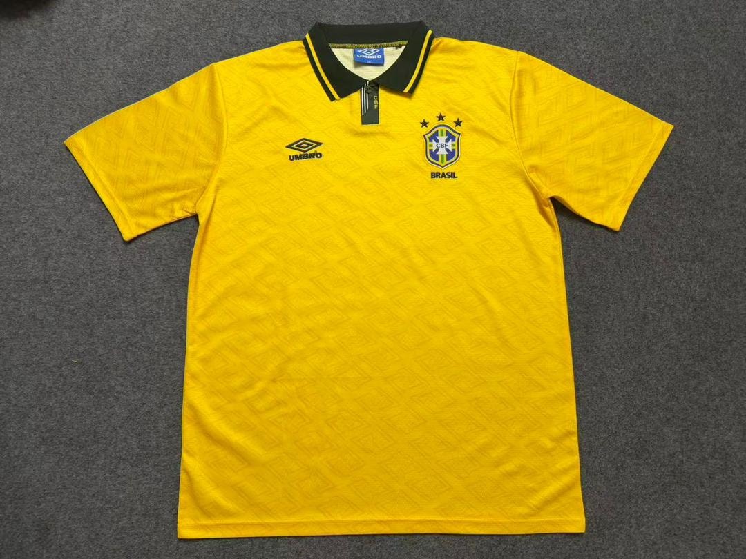 Yellow Umbro Brazil football polo jersey laid flat.