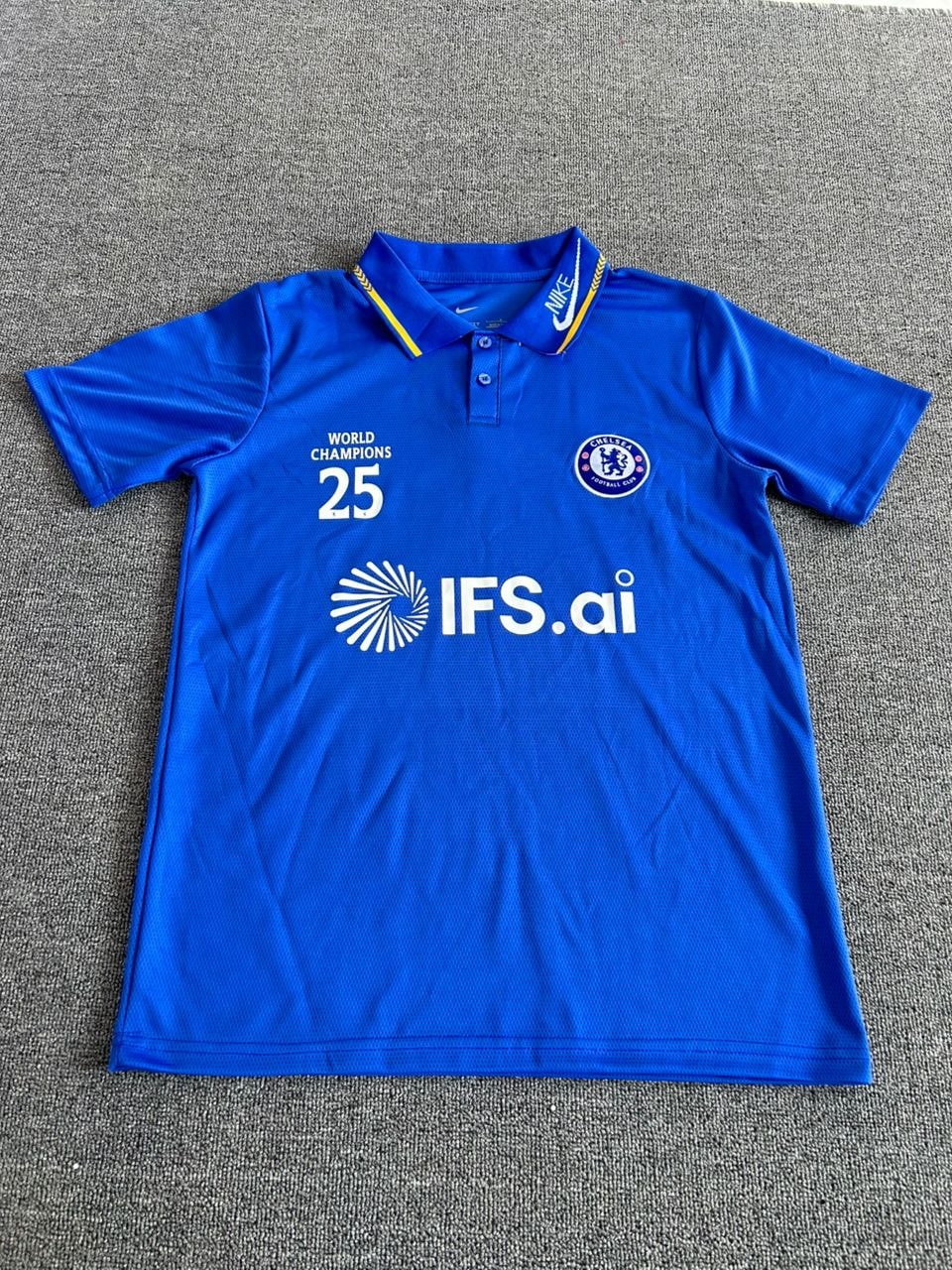 Blue Nike Chelsea polo jersey with IFS.ai sponsor laid flat.