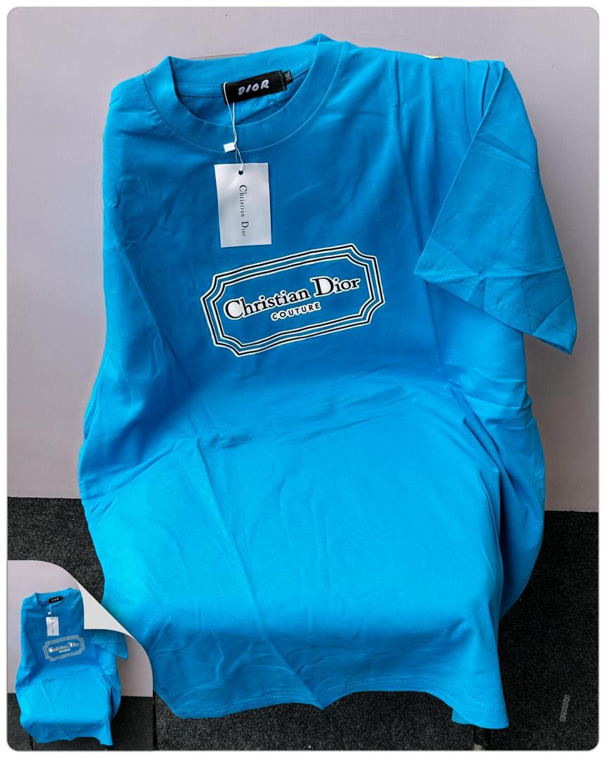 Bright blue Christian Dior Couture logo t-shirt on stand.