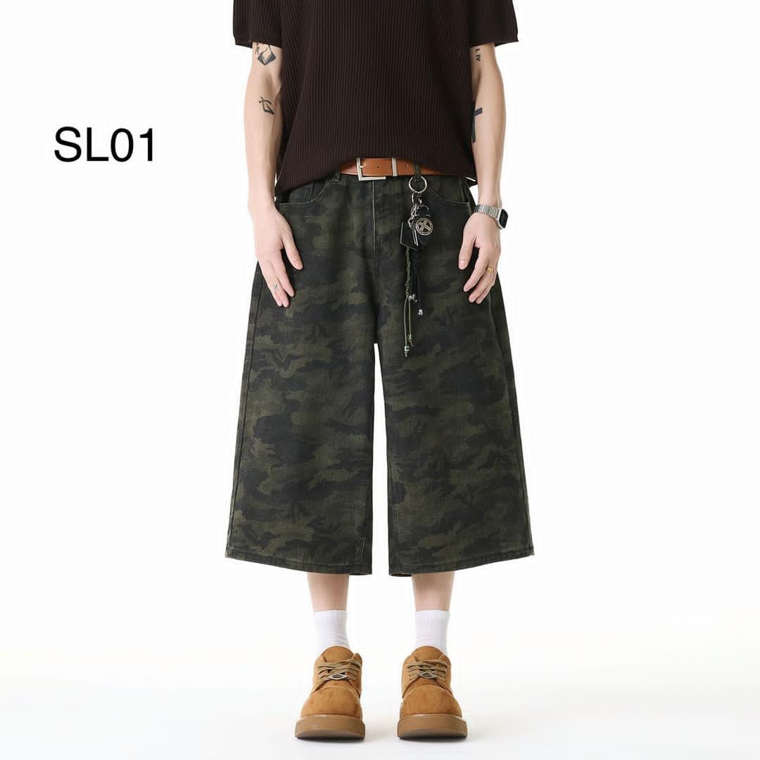 Model wearing olive camouflage wide-leg 3/4 shorts with brown top and boots.