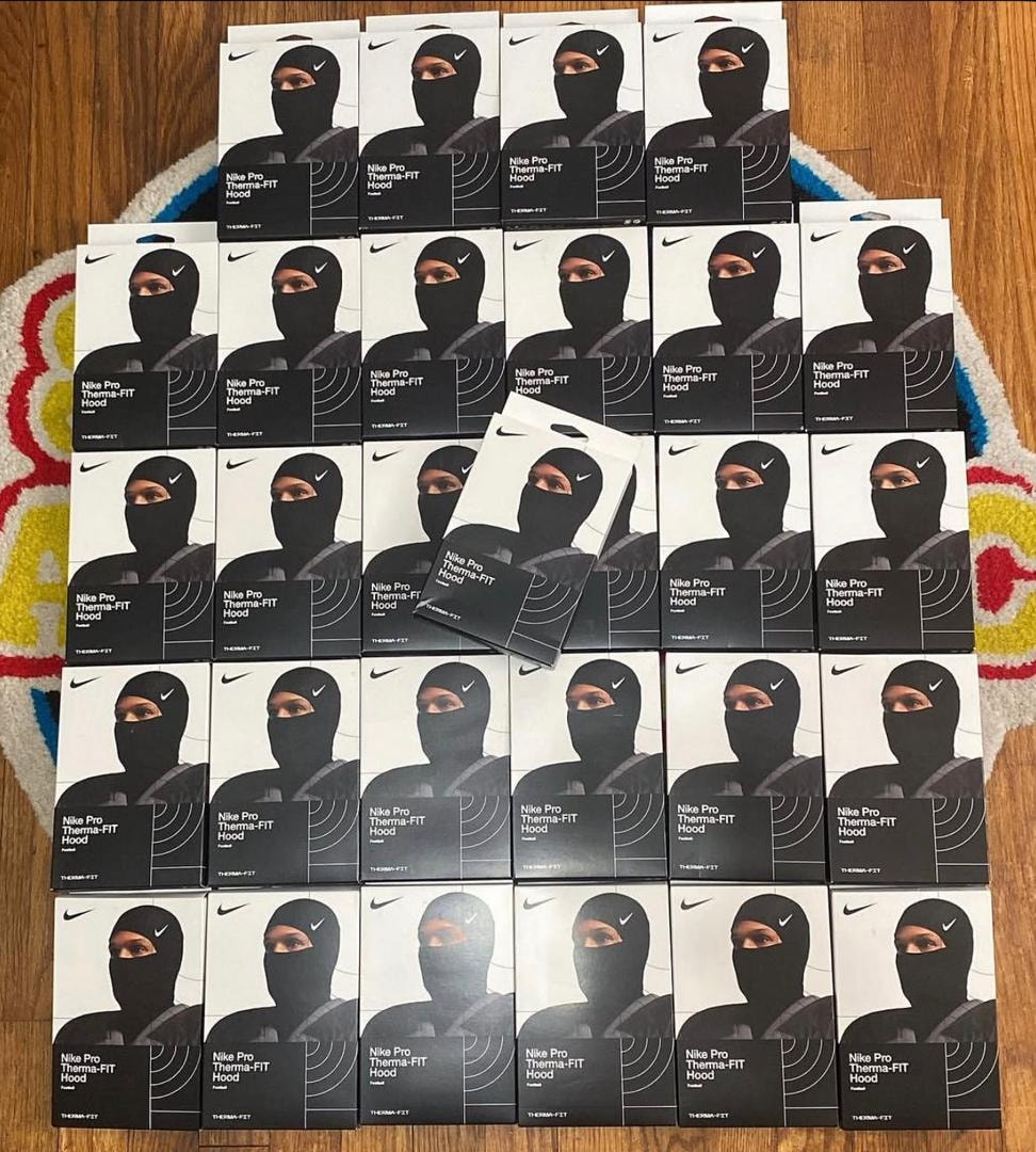 Large grid of Nike Pro Therma-FIT Hood product boxes arranged on floor.