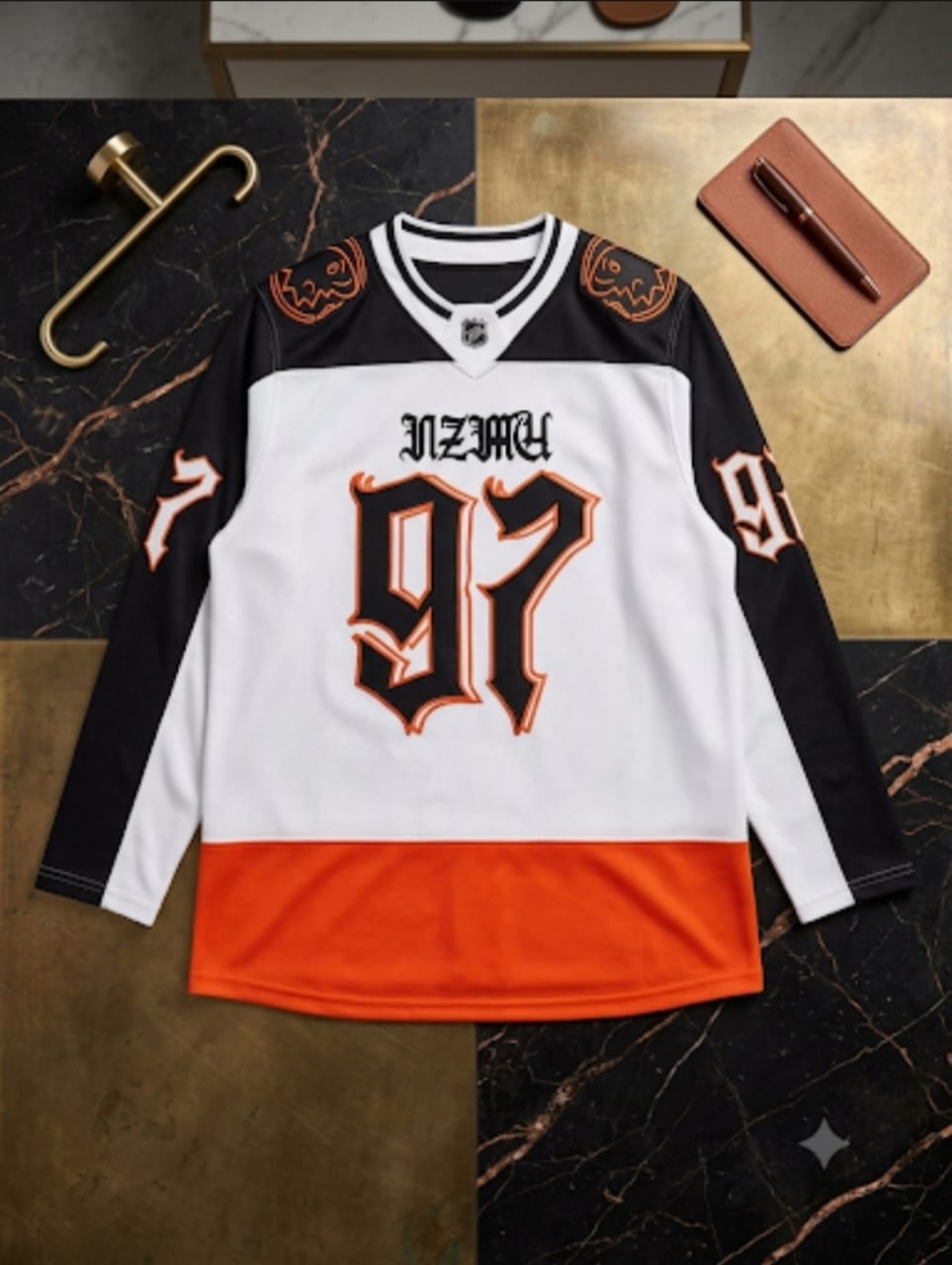 Black white and orange 97 hockey jersey flat lay with accessories.