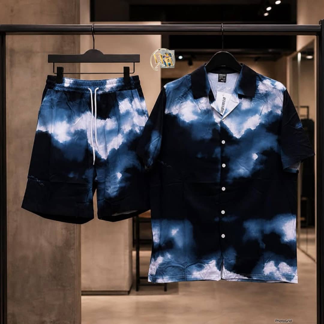 Blue and black tie-dye short sleeve shirt and shorts set with cloud pattern on display rack.