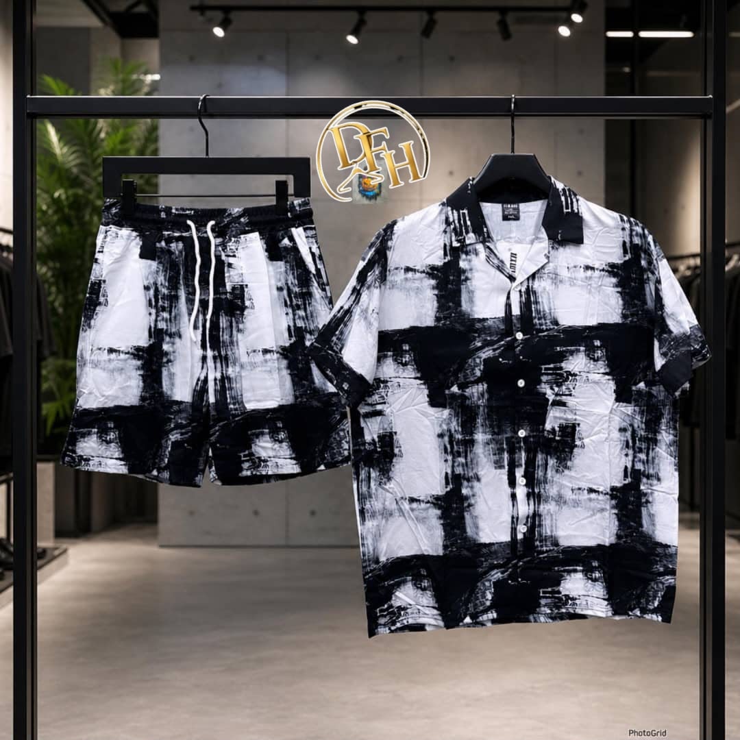 Black and white short sleeve shirt and shorts set with abstract brush stroke print displayed on rack.