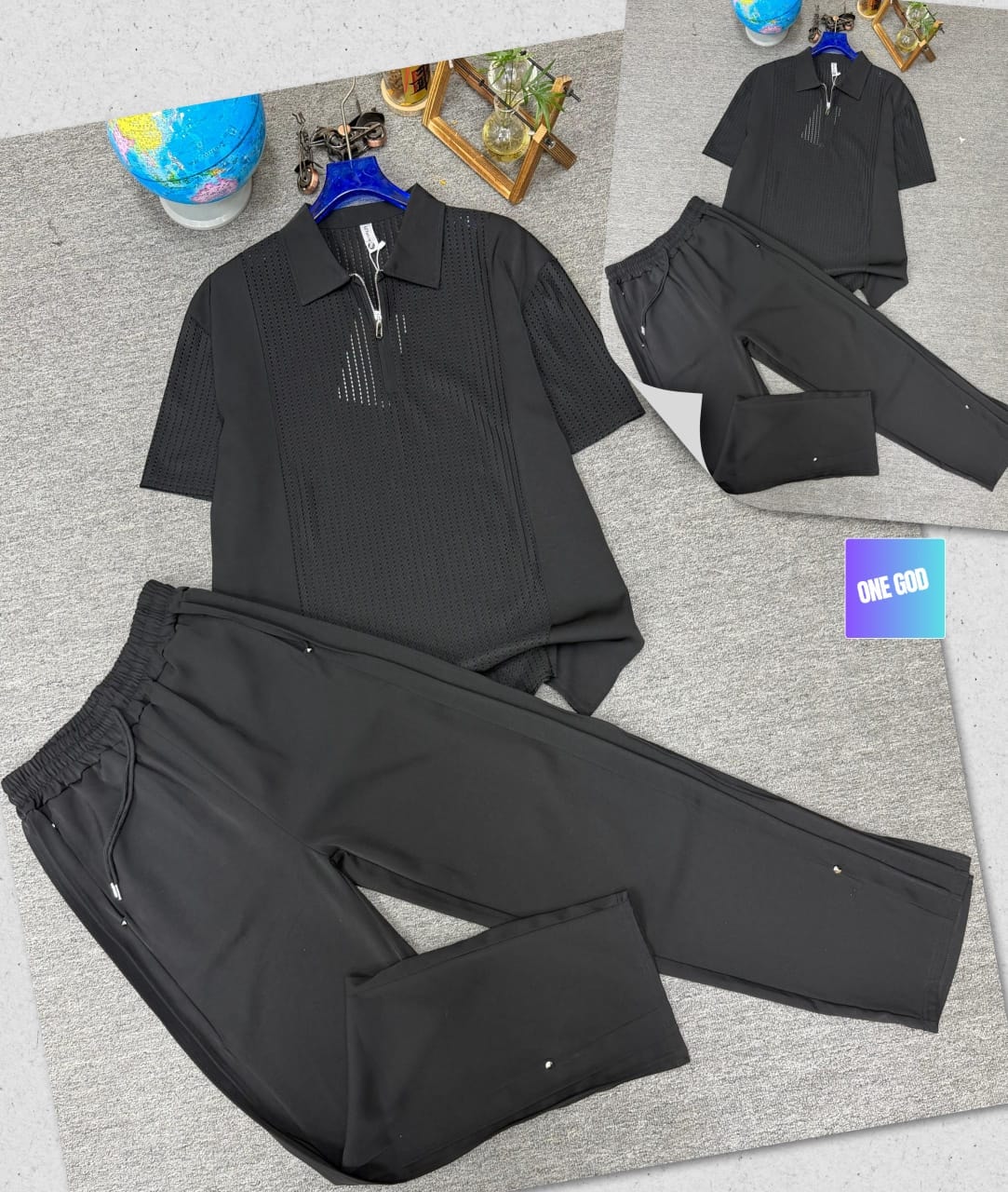 Black two-piece set with perforated zip polo shirt and matching trousers.