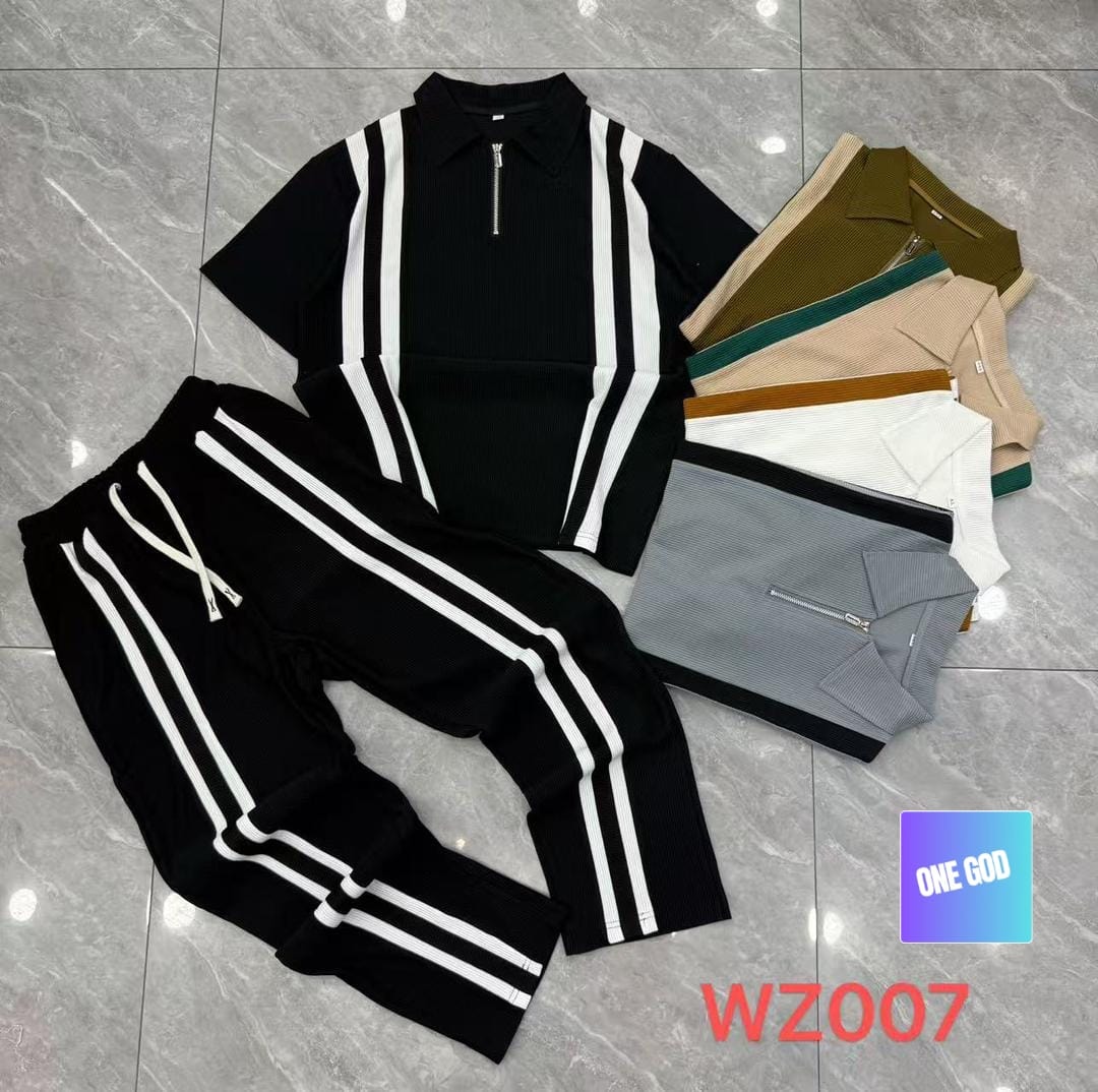 Flat lay of multiple colorways of striped ribbed two-piece sets including black with white stripes