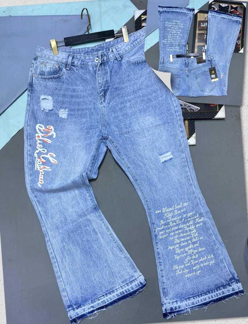 Light blue baggy jeans with colorful leg script, white text print, and rips, multiple angled views.