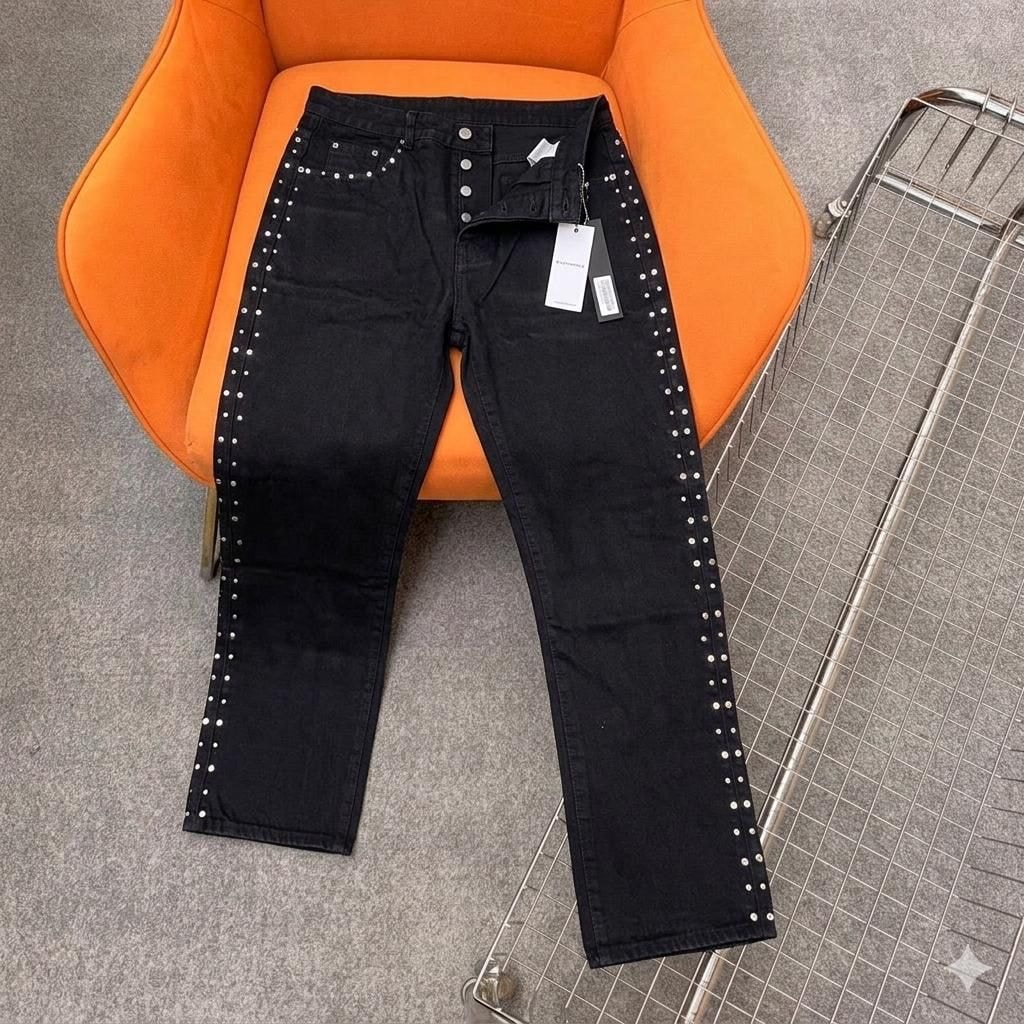 Black jeans with silver studs lining both outer side seams.
