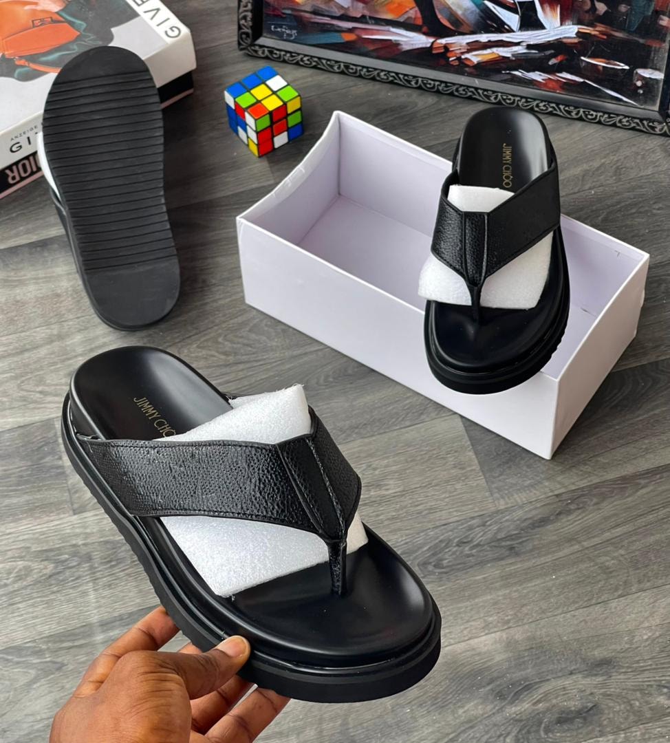 Black thong slide with textured strap and JIMMY CHOO branding on insole.