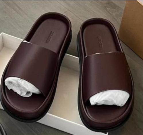 Pair of brown platform slides in white box with tissue inserts.