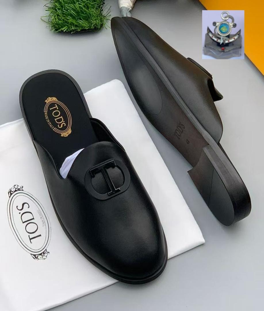 Black Tod's mule with T logo on insole and sole, shown from multiple angles with dust bag.