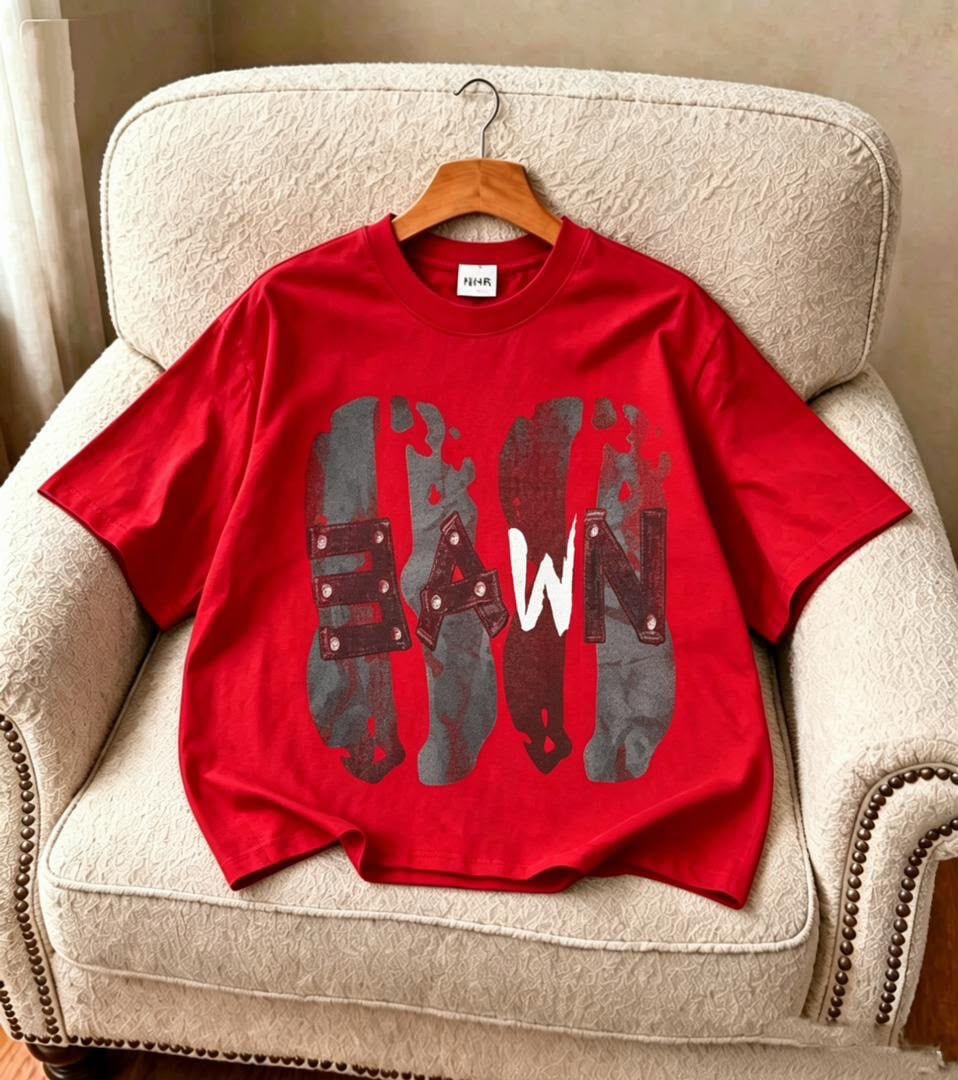Red Dawn graphic t-shirt with stylized lettering, displayed on chair.