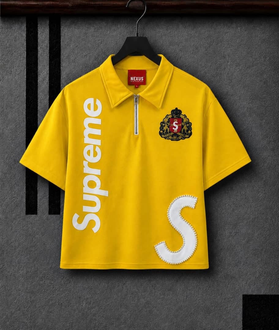 Yellow half-zip polo shirt with vertical Supreme print, crest logo and white pearl embellished S.