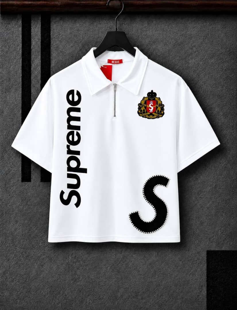 White half-zip polo shirt with vertical Supreme print, crest logo and black embellished S.