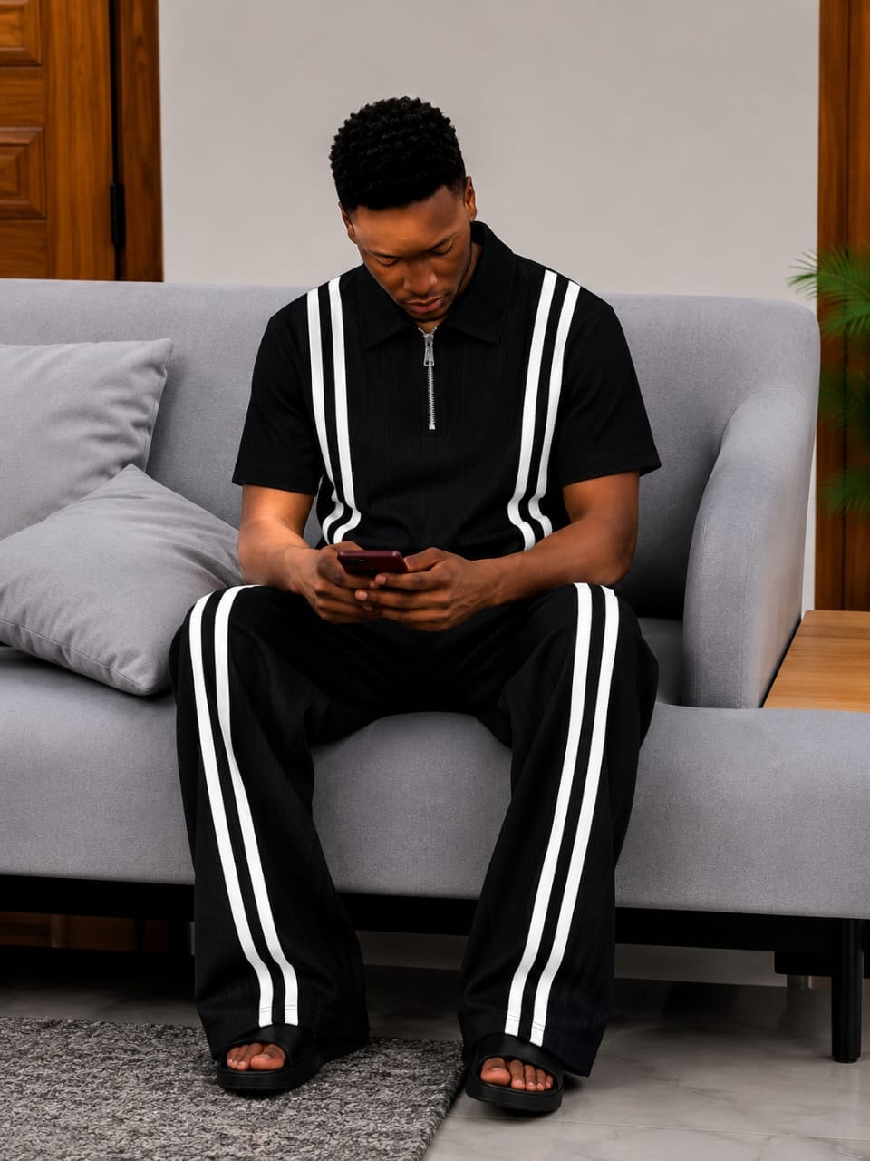 Man wearing black ribbed 2-piece set with white contrast stripes.