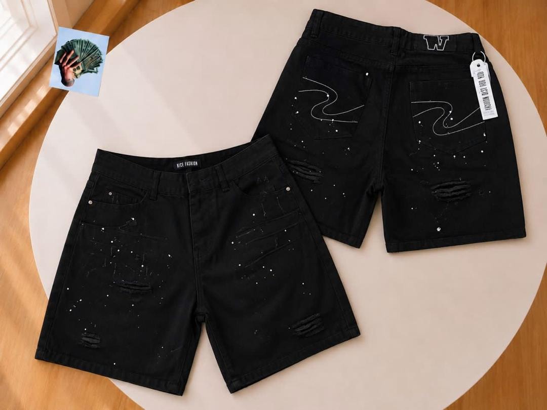 Front and back of black denim shorts with white splatter and line designs.