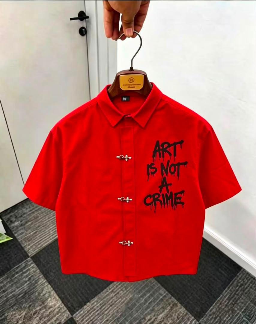 Red short sleeve shirt with ART IS NOT A CRIME print on front.