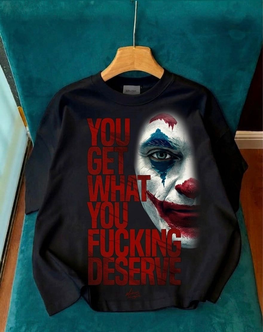 Black long sleeve tee with Joker face and large red text reading YOU GET WHAT YOU FUCKING DESERVE.