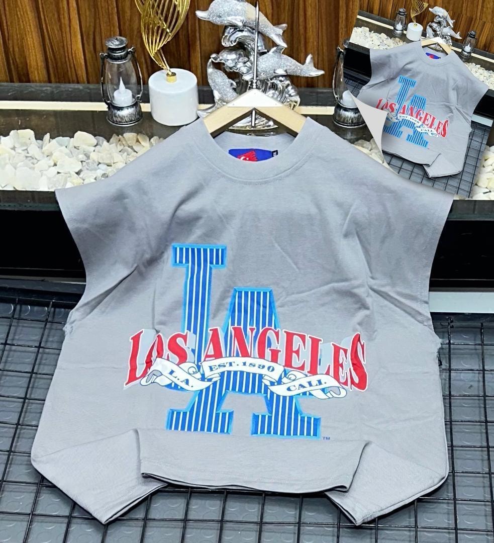 Gray oversized armless top with large Los Angeles graphic print on chest.